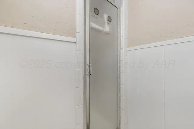 a bathroom with a glass shower door