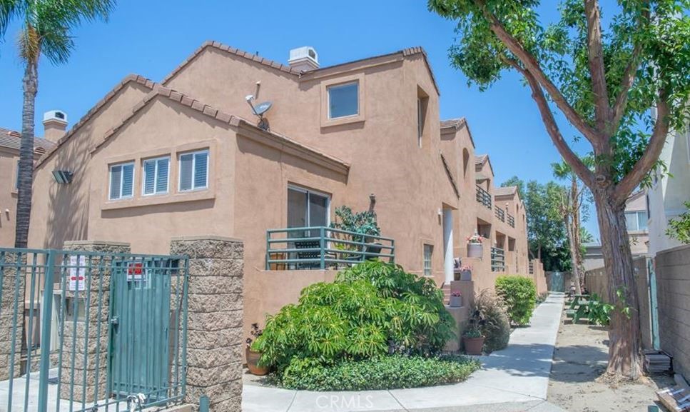 a view of a white house next to a yard