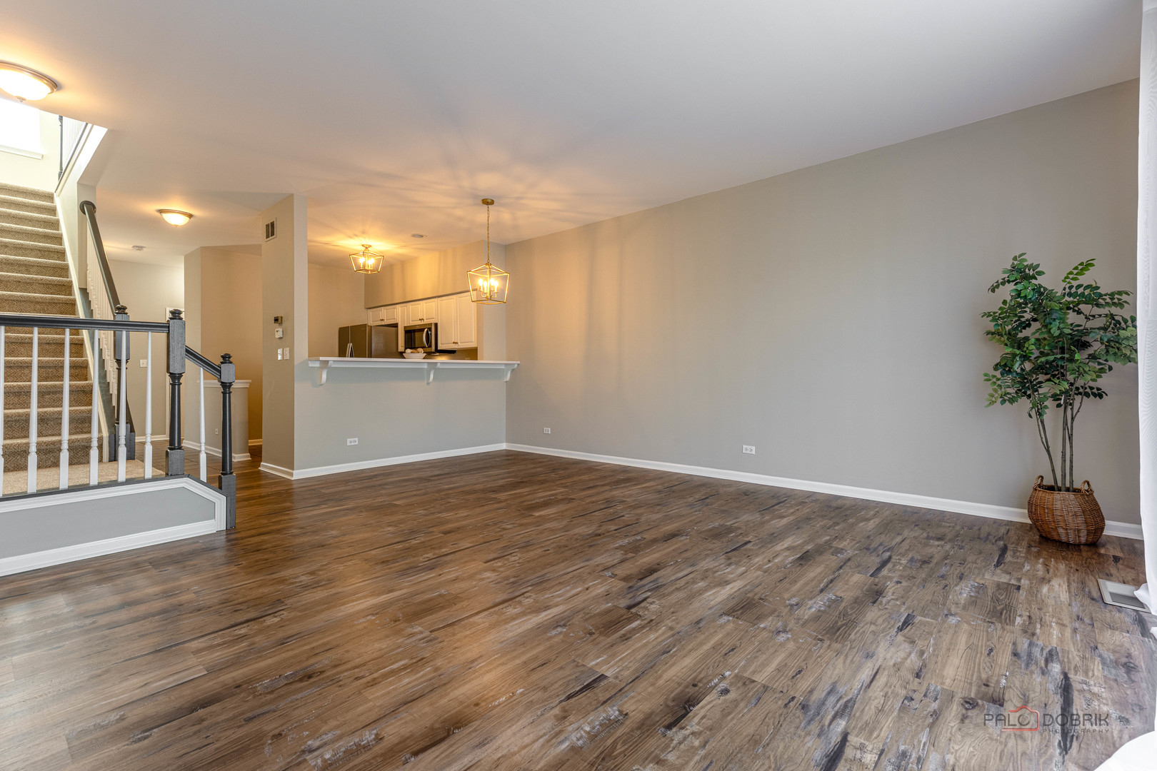 263 Camel Bend Court Schaumburg, IL 60107 - Photo 11 of 24 a view of a room with wooden floor and a potted plant