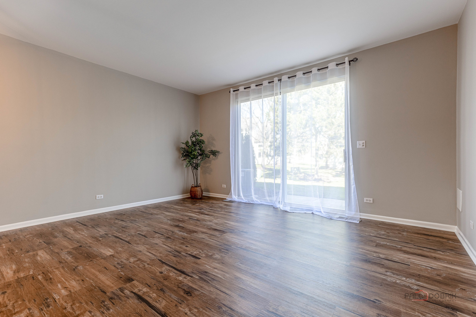 263 Camel Bend Court Schaumburg, IL 60107 - Photo 13 of 24 a view of an empty room with wooden floor and a window