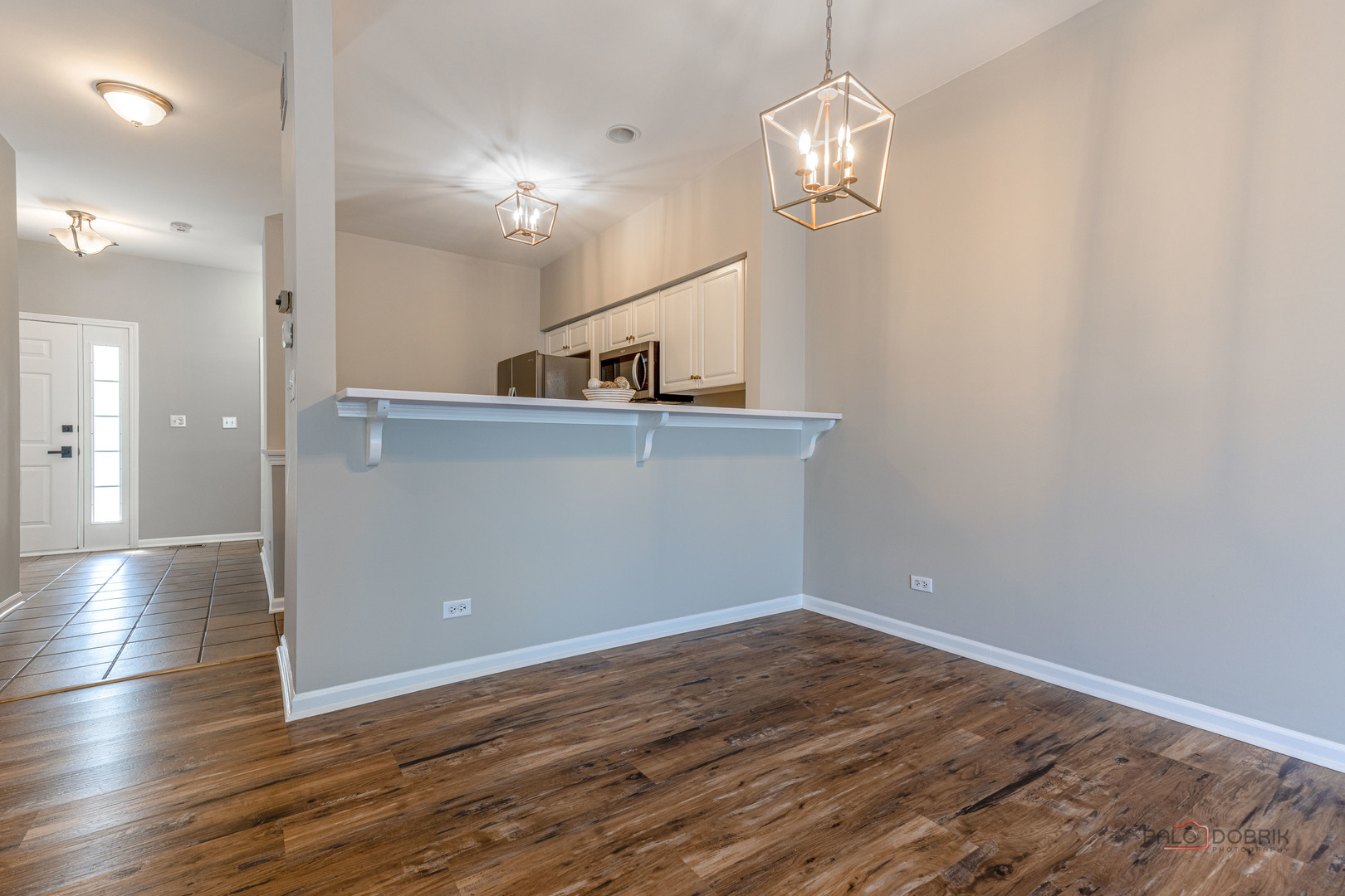 263 Camel Bend Court Schaumburg, IL 60107 - Photo 7 of 24 a view of a hallway with wooden floor and chandelier