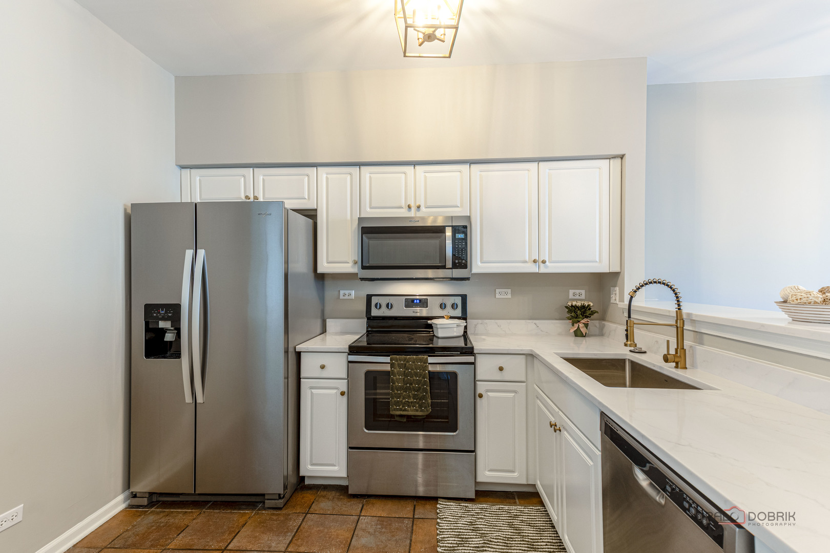 263 Camel Bend Court Schaumburg, IL 60107 - Photo 8 of 24 a kitchen with white cabinets and stainless steel appliances