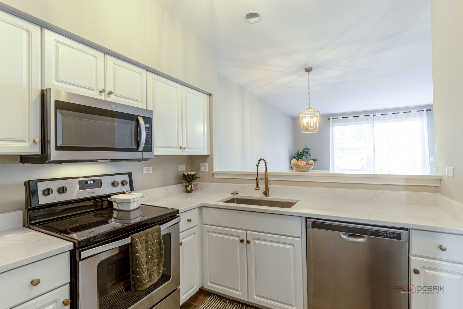 263 Camel Bend Court Schaumburg, IL 60107 - Photo 9 of 24 a kitchen with granite countertop a sink dishwasher stove and microwave with wooden cabinets