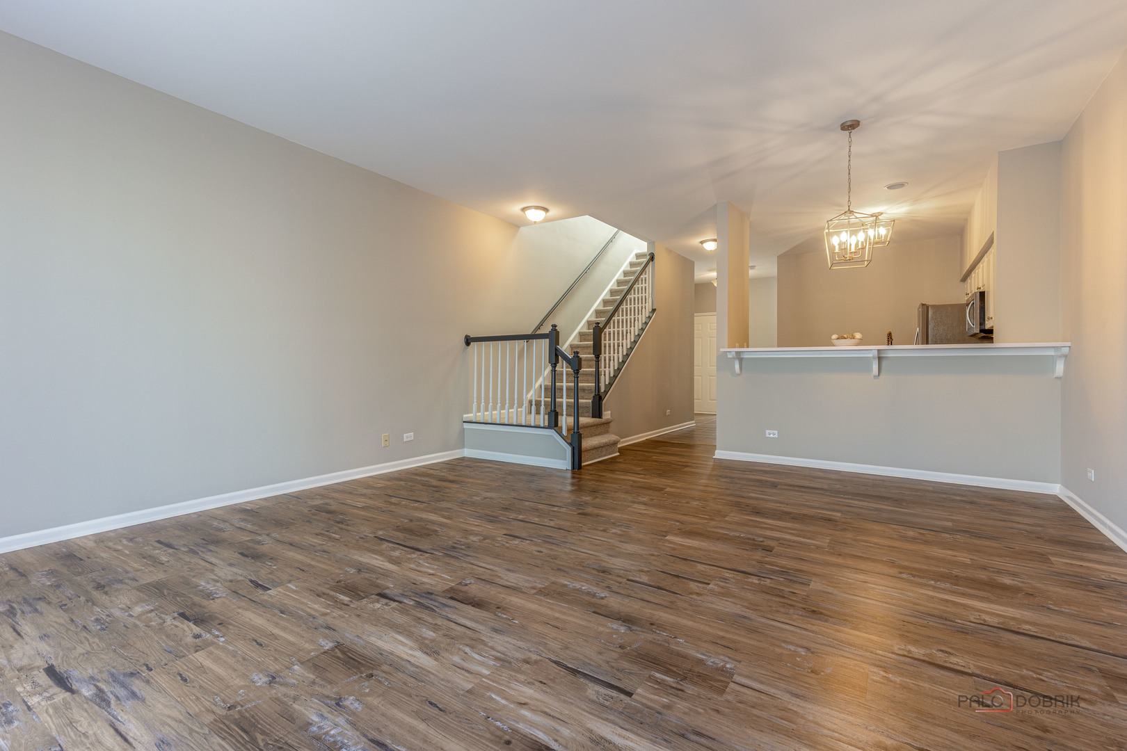 263 Camel Bend Court Schaumburg, IL 60107 - Photo 10 of 24 a view of a room with wooden floor and stairs