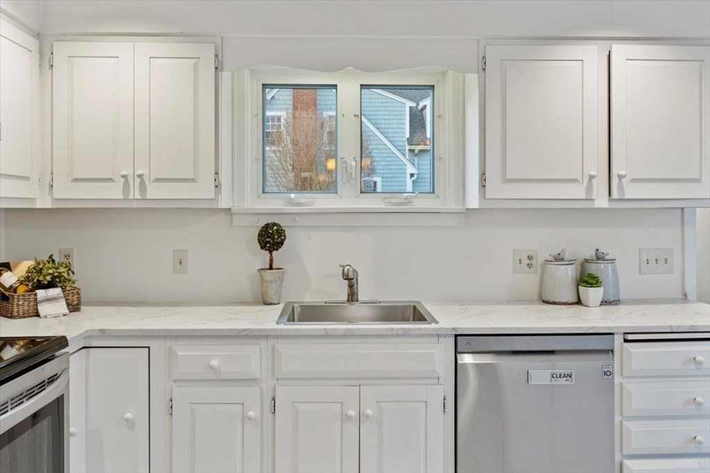 54 Ober Street Beverly, MA 01915 - Photo 13 of 40 a kitchen with white cabinets and a sink