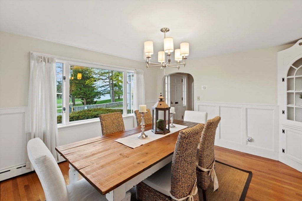 54 Ober Street Beverly, MA 01915 - Photo 14 of 40 a view of a dining room with furniture a chandelier and wooden floor