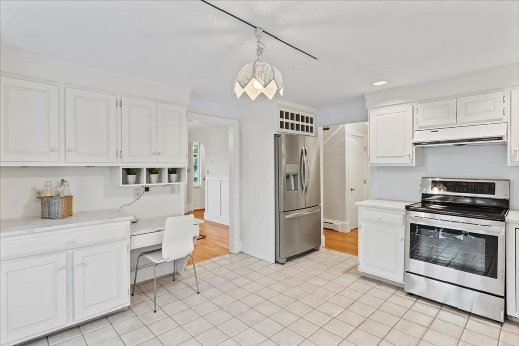 54 Ober Street Beverly, MA 01915 - Photo 15 of 40 a kitchen with white cabinets and stainless steel appliances