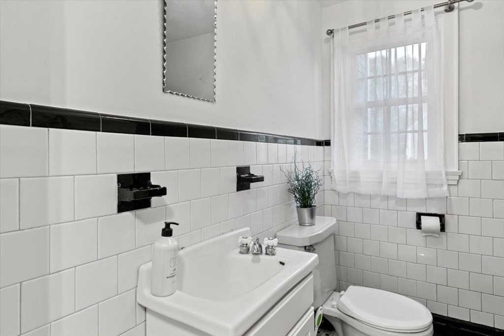 54 Ober Street Beverly, MA 01915 - Photo 18 of 40 a bathroom with a sink a toilet and shower