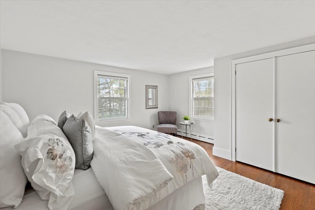 54 Ober Street Beverly, MA 01915 - Photo 21 of 40 a bed sitting in a bedroom next to a window and a wooden floor