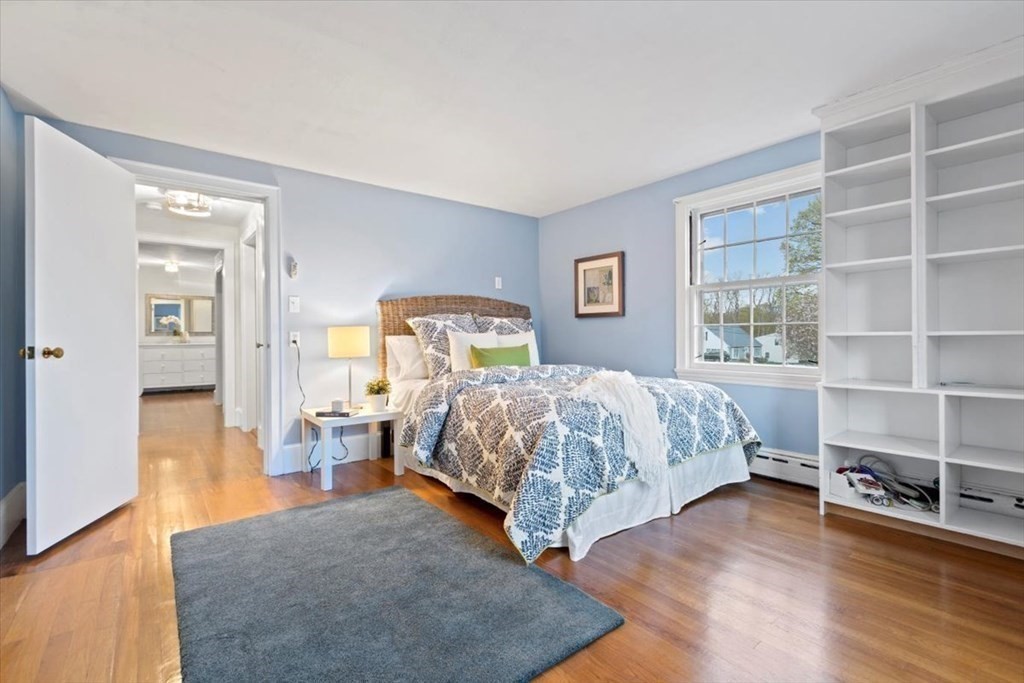 54 Ober Street Beverly, MA 01915 - Photo 26 of 40 a bedroom with a bed a table and painting