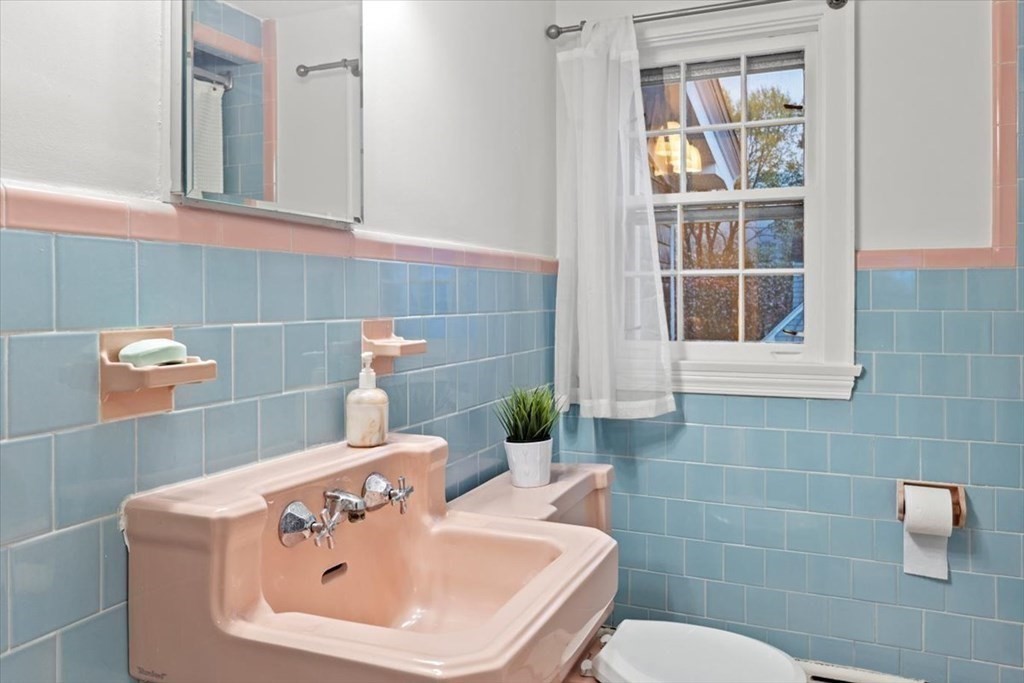 54 Ober Street Beverly, MA 01915 - Photo 31 of 40 a bathroom with a sink a toilet and a mirror