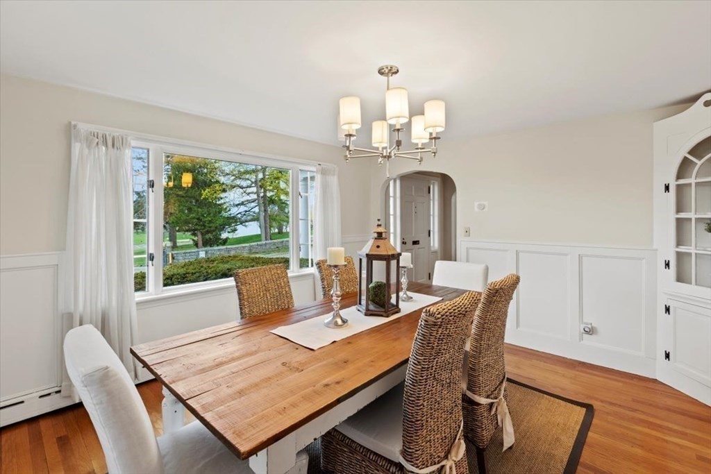 54 Ober Street Beverly, MA 01915 - Photo 9 of 40 a view of a dining room with furniture a chandelier and wooden floor