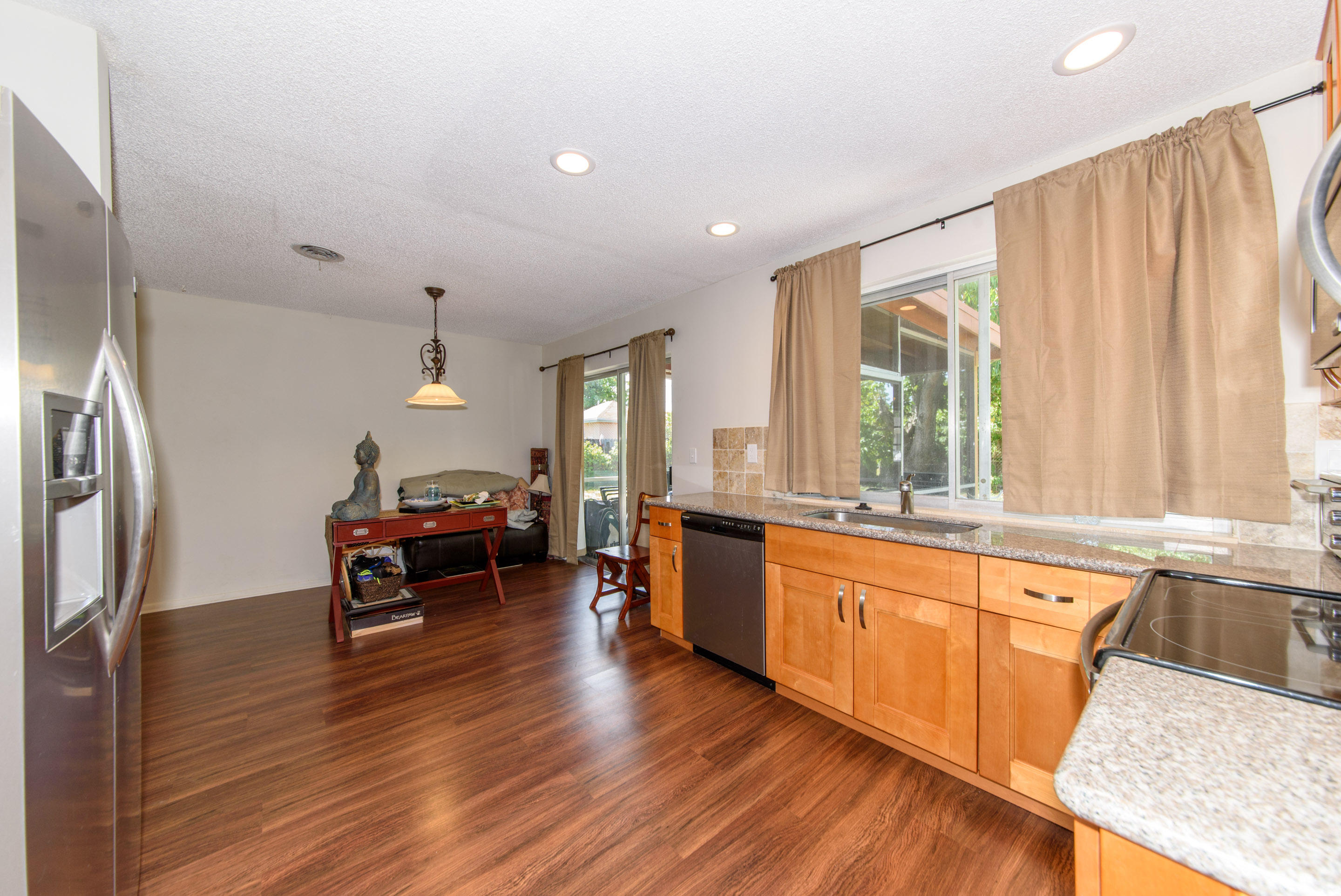 700 Southwest 14th Street Deerfield Beach, FL 33441 - Photo 11 of 13 a kitchen with stainless steel appliances granite countertop a sink a stove and wooden floors