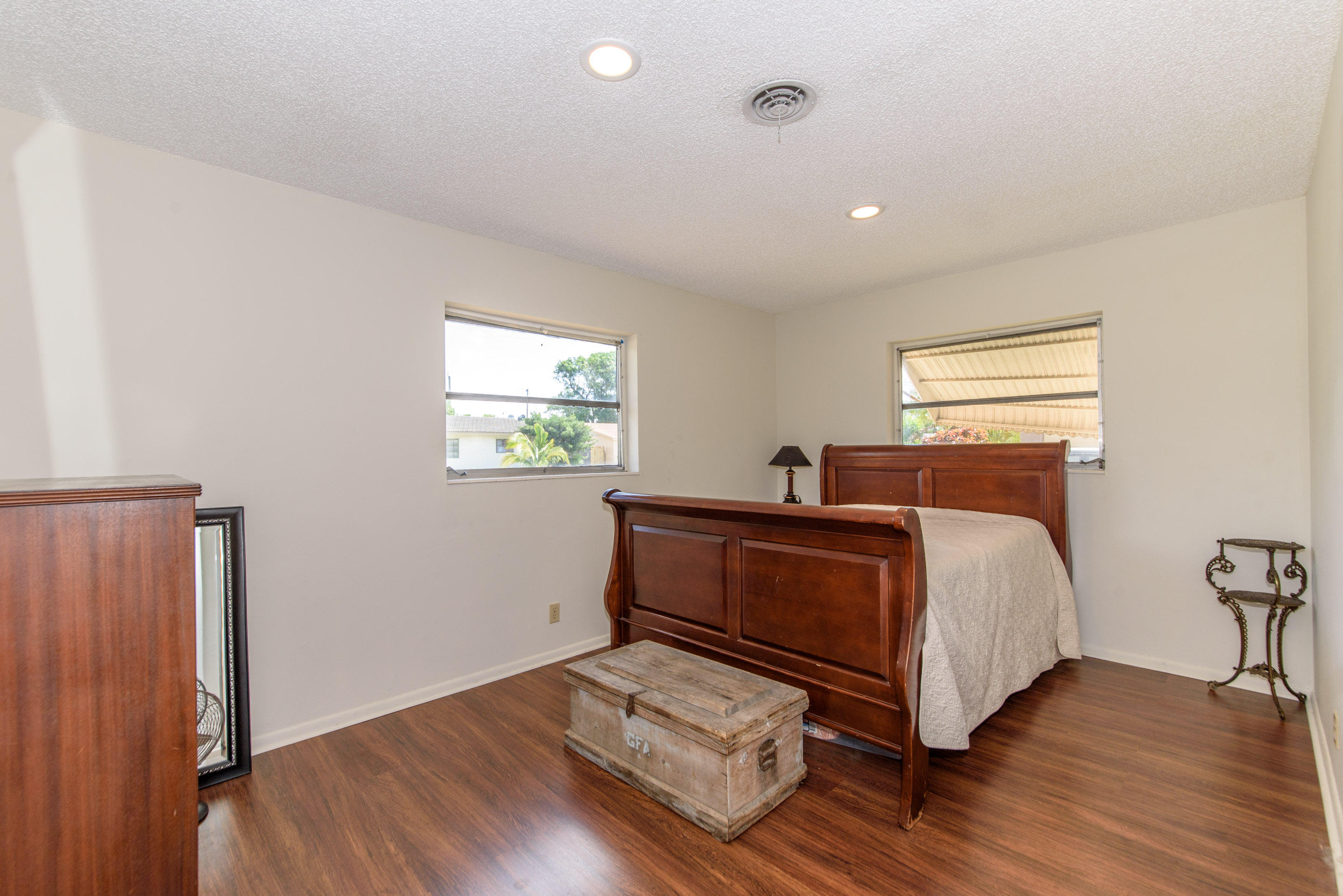 700 Southwest 14th Street Deerfield Beach, FL 33441 - Photo 7 of 13 a bedroom with a bed and wooden floor