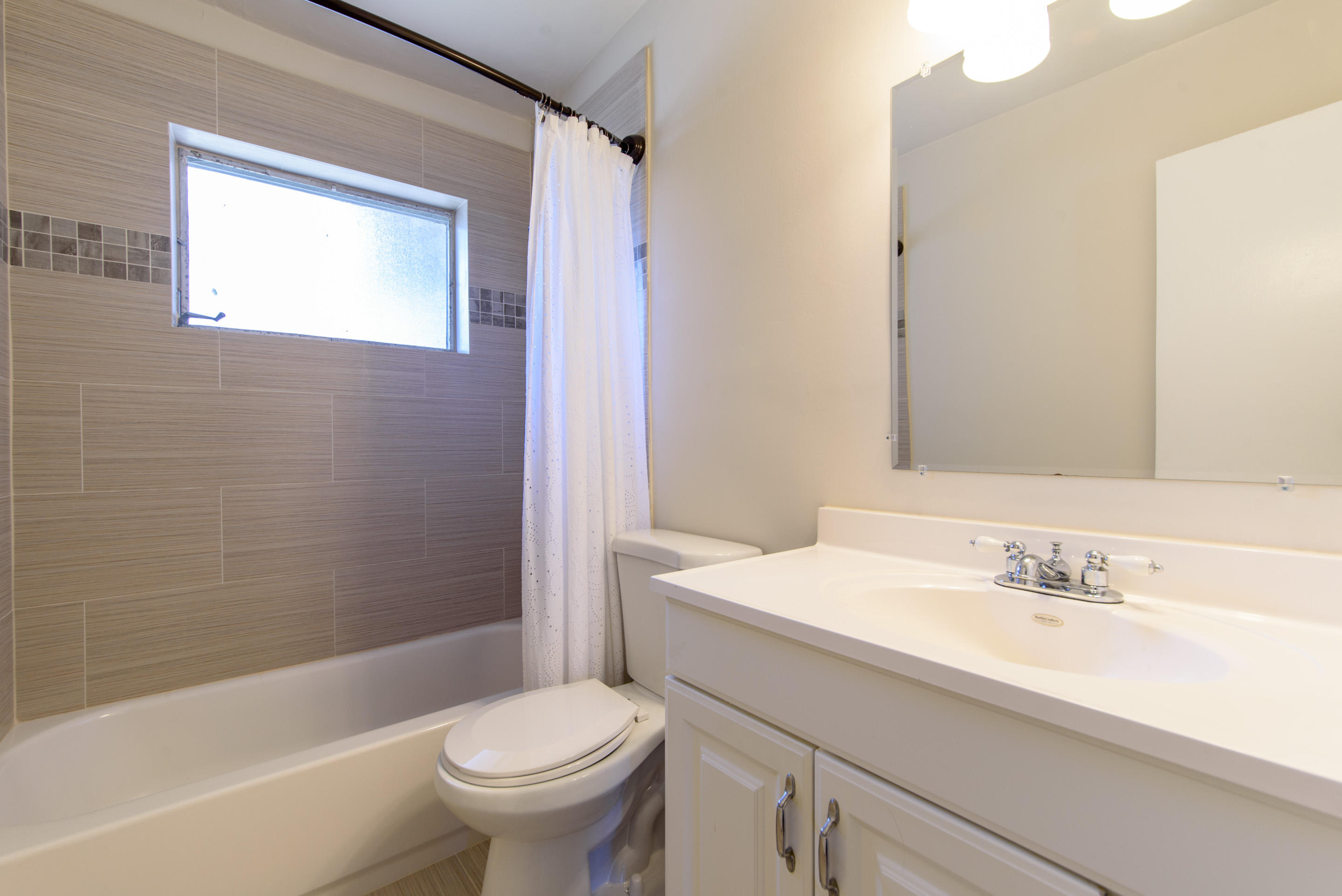 700 Southwest 14th Street Deerfield Beach, FL 33441 - Photo 8 of 13 a bathroom with a sink a toilet and a bathtub