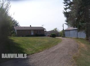 a view of house with backyard space and garden