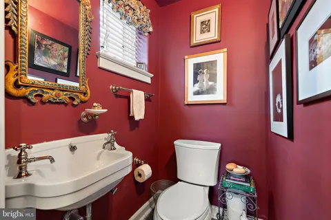 a white toilet sitting next to a bathroom sink
