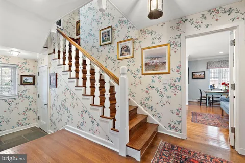a view of an entryway with wooden floor and a front door