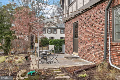 a view of a patio with table and chairs with wooden fence and plants