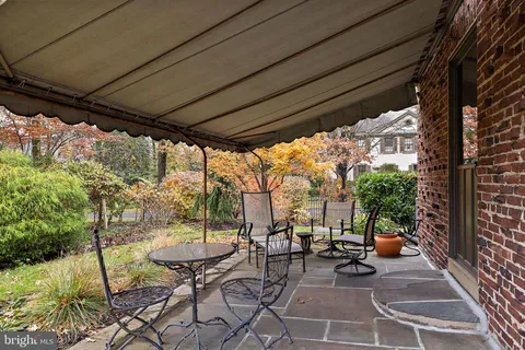 a view of a porch with chairs and backyard