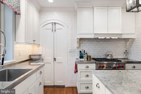 a kitchen with cabinets a sink and appliances