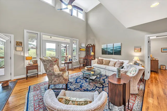 a kitchen with stainless steel appliances granite countertop a stove a refrigerator a kitchen island and chairs in it