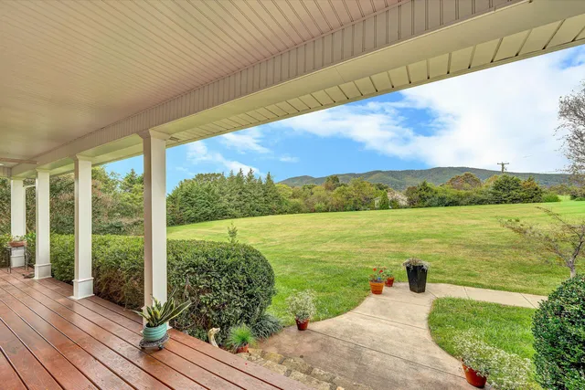 a view of a balcony with chair and wooden floor