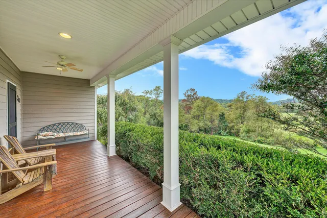 a view of a patio with table and chairs and wooden floor
