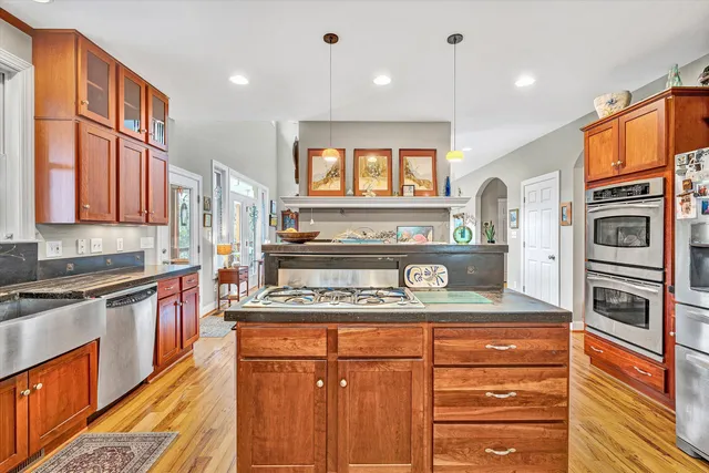 a kitchen with stainless steel appliances granite countertop a refrigerator and a sink