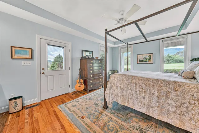 a spacious bathroom with a granite countertop toilet sink and mirror