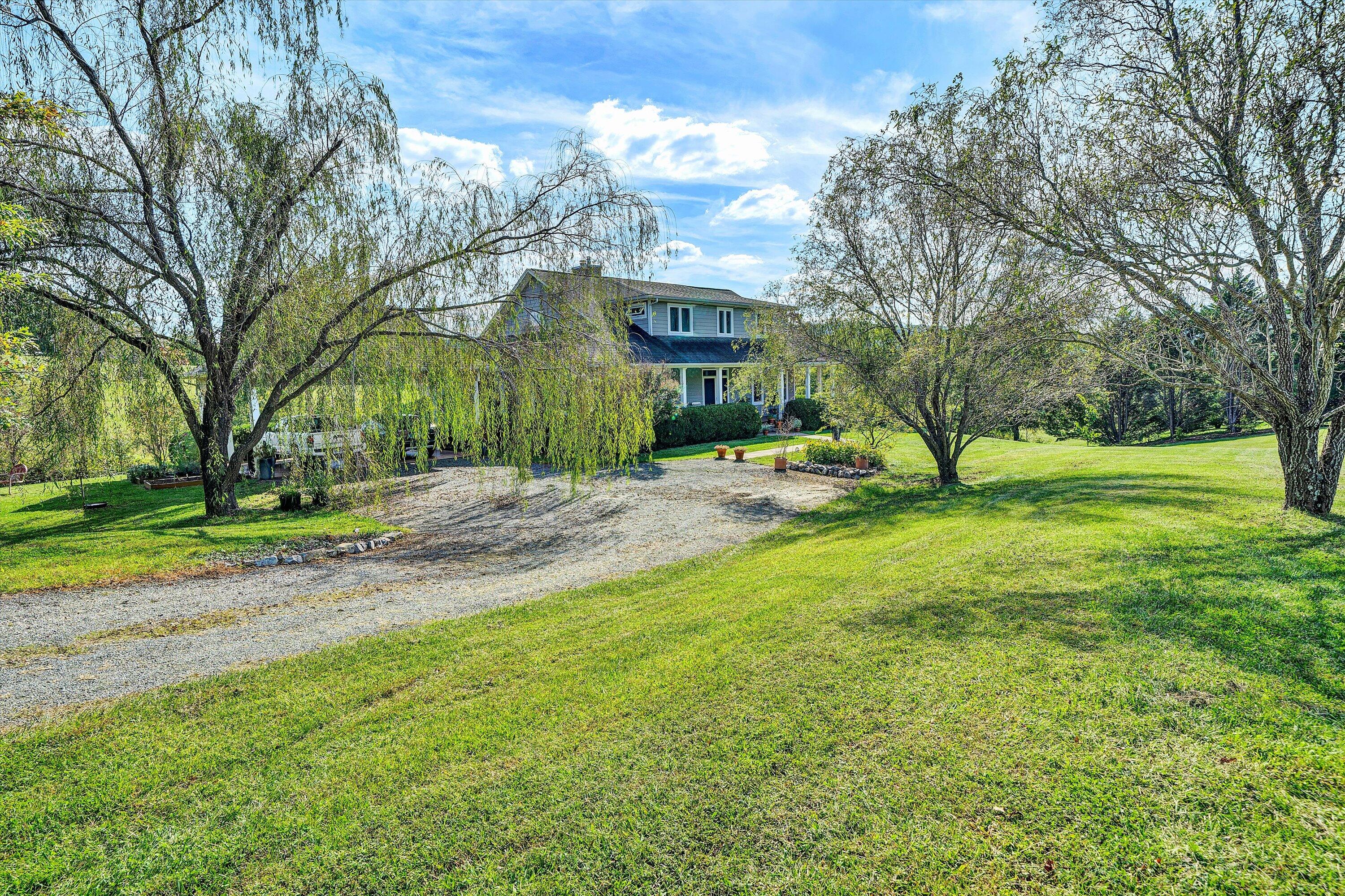 84 Green Level Road Boones Mill, VA 24065 - Photo 48 of 57 a backyard of a house with lots of green space and fountain
