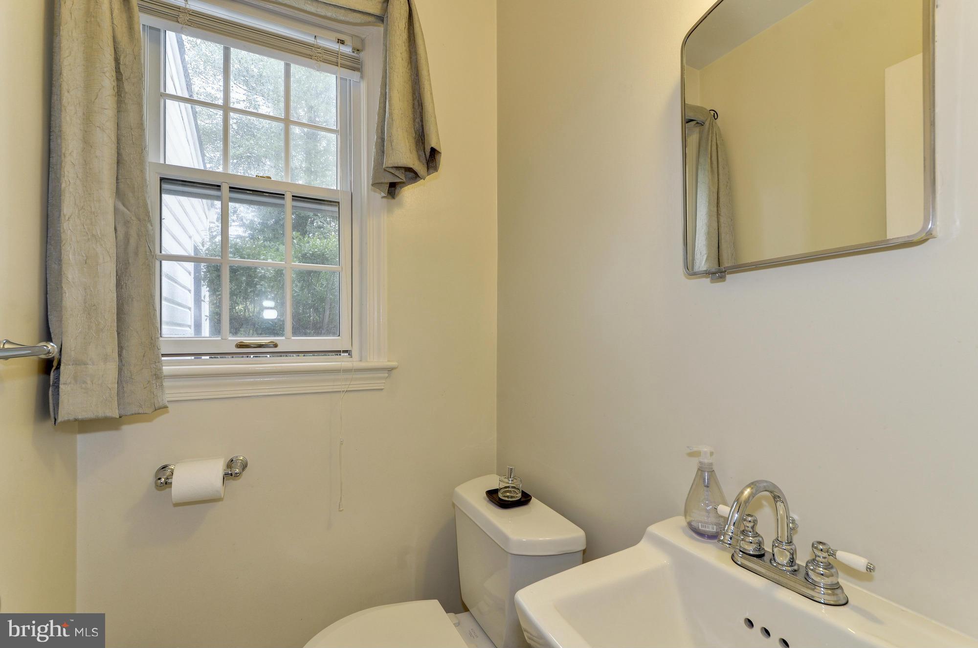 8822 Ridge Road Bethesda, MD 20817 - Photo 11 of 20 a bathroom with a toilet sink and mirror