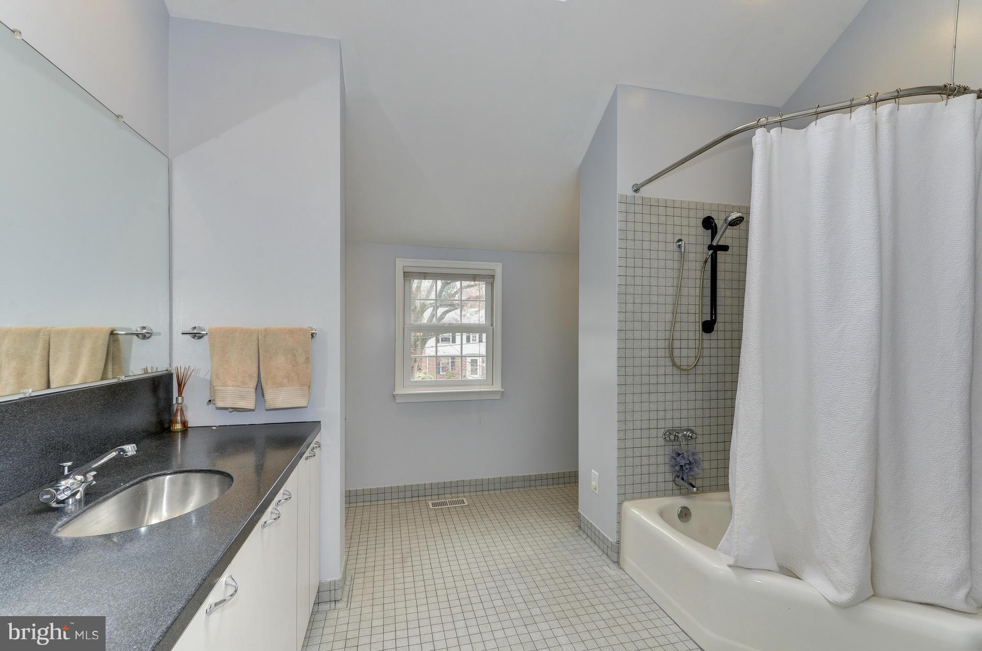 8822 Ridge Road Bethesda, MD 20817 - Photo 13 of 20 a bathroom with a tub sink and mirror