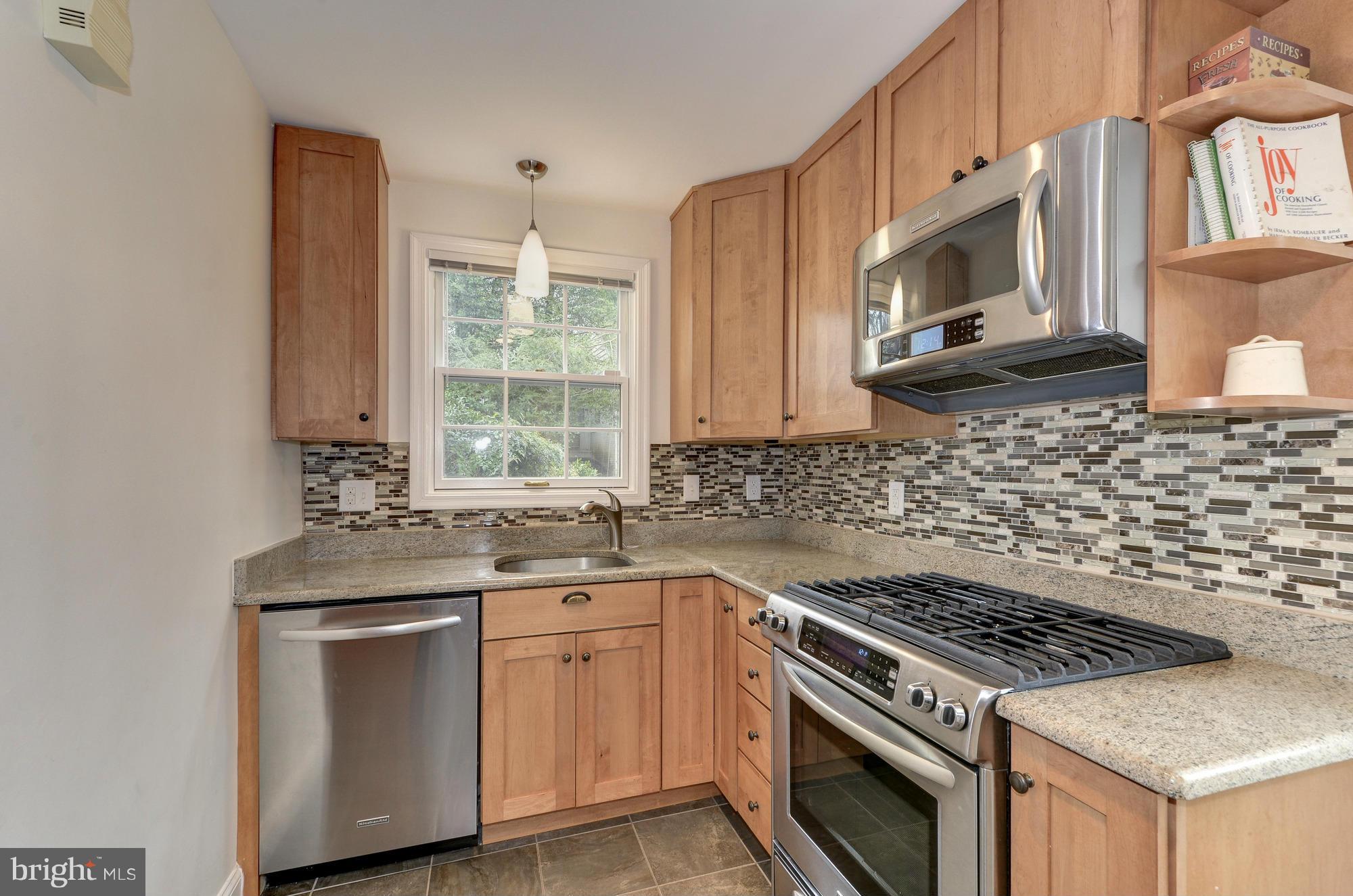 8822 Ridge Road Bethesda, MD 20817 - Photo 5 of 20 a kitchen with granite countertop a stove sink and microwave