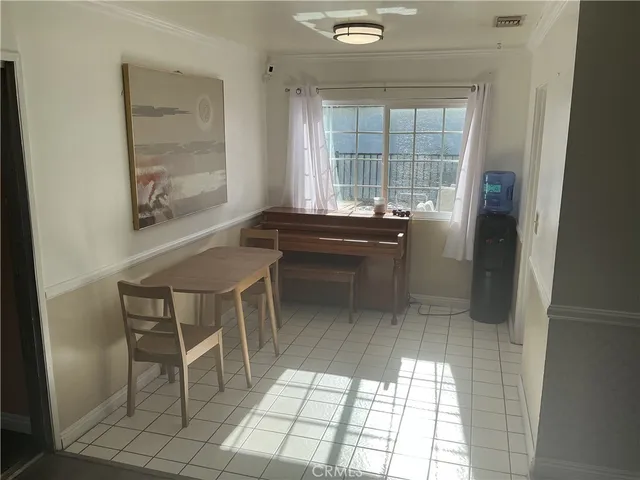 a dining room with furniture and window