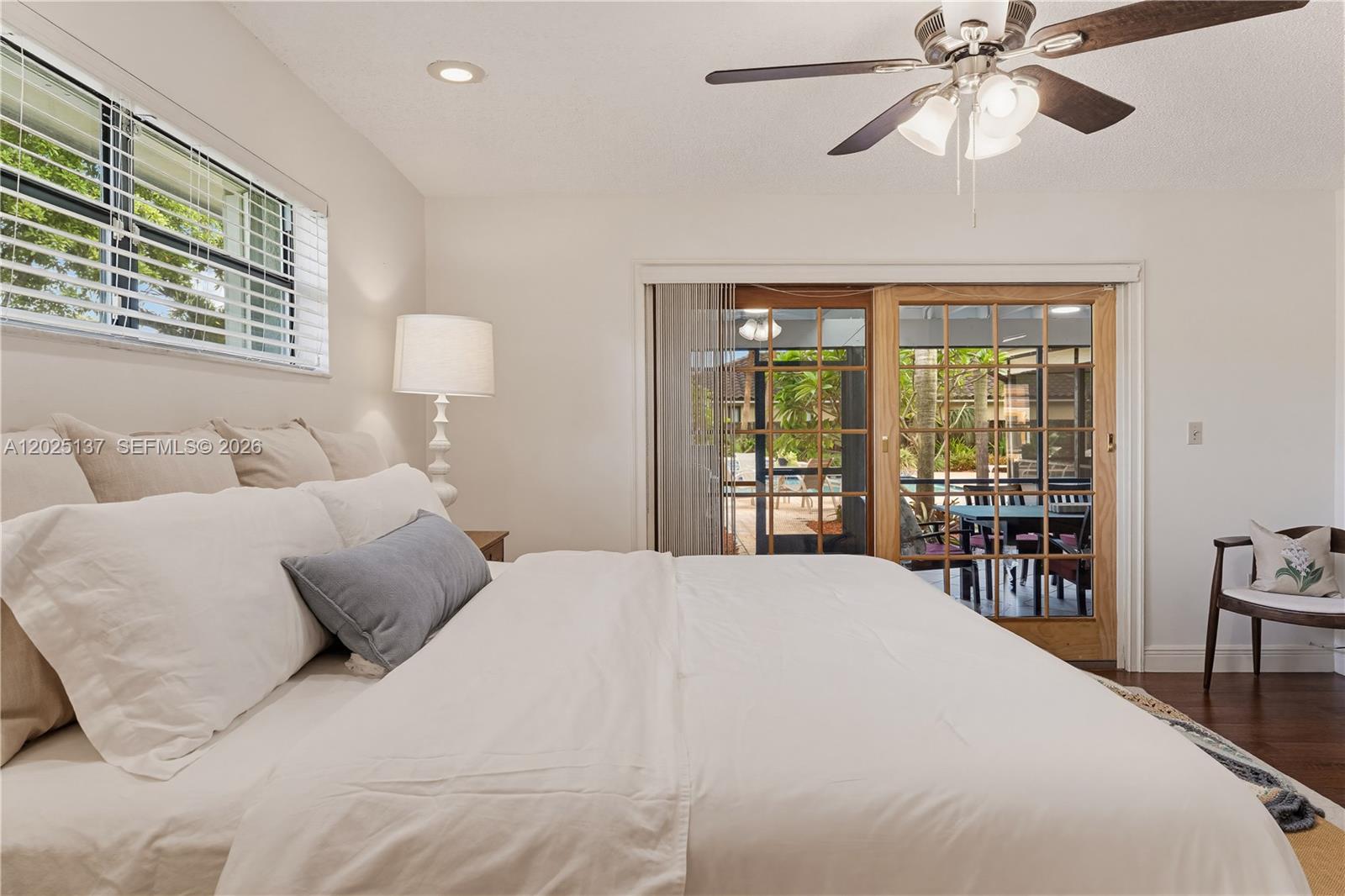 11480 Southwest 96th Terrace Miami, FL 33176 - Photo 30 of 54 a bedroom with a large bed and a chandelier