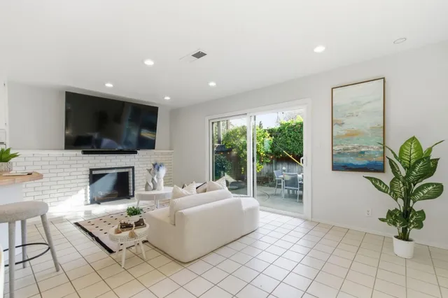 a kitchen with kitchen island a sink stove and refrigerator