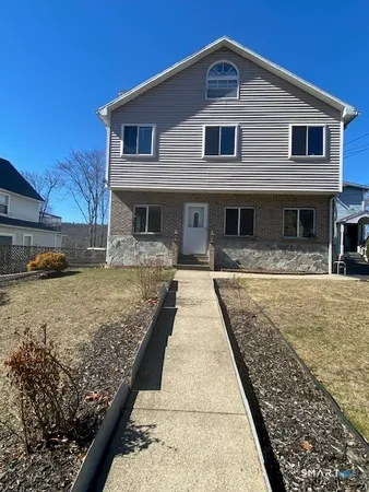 a front view of a house with a yard