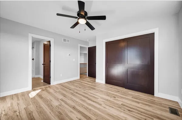 a view of empty room with wooden floor