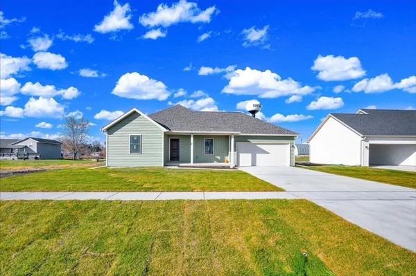 a front view of a house with a big yard