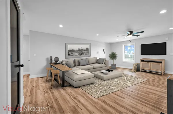 a living room with furniture and a flat screen tv