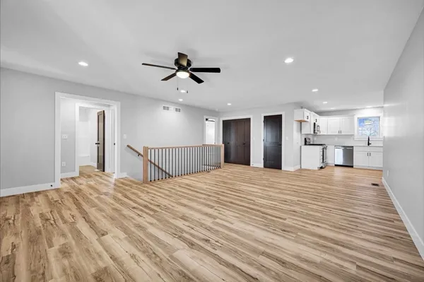 a large bedroom with a bed and a chandelier