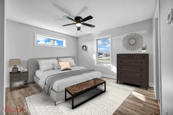 a bedroom with a bed and wooden floor