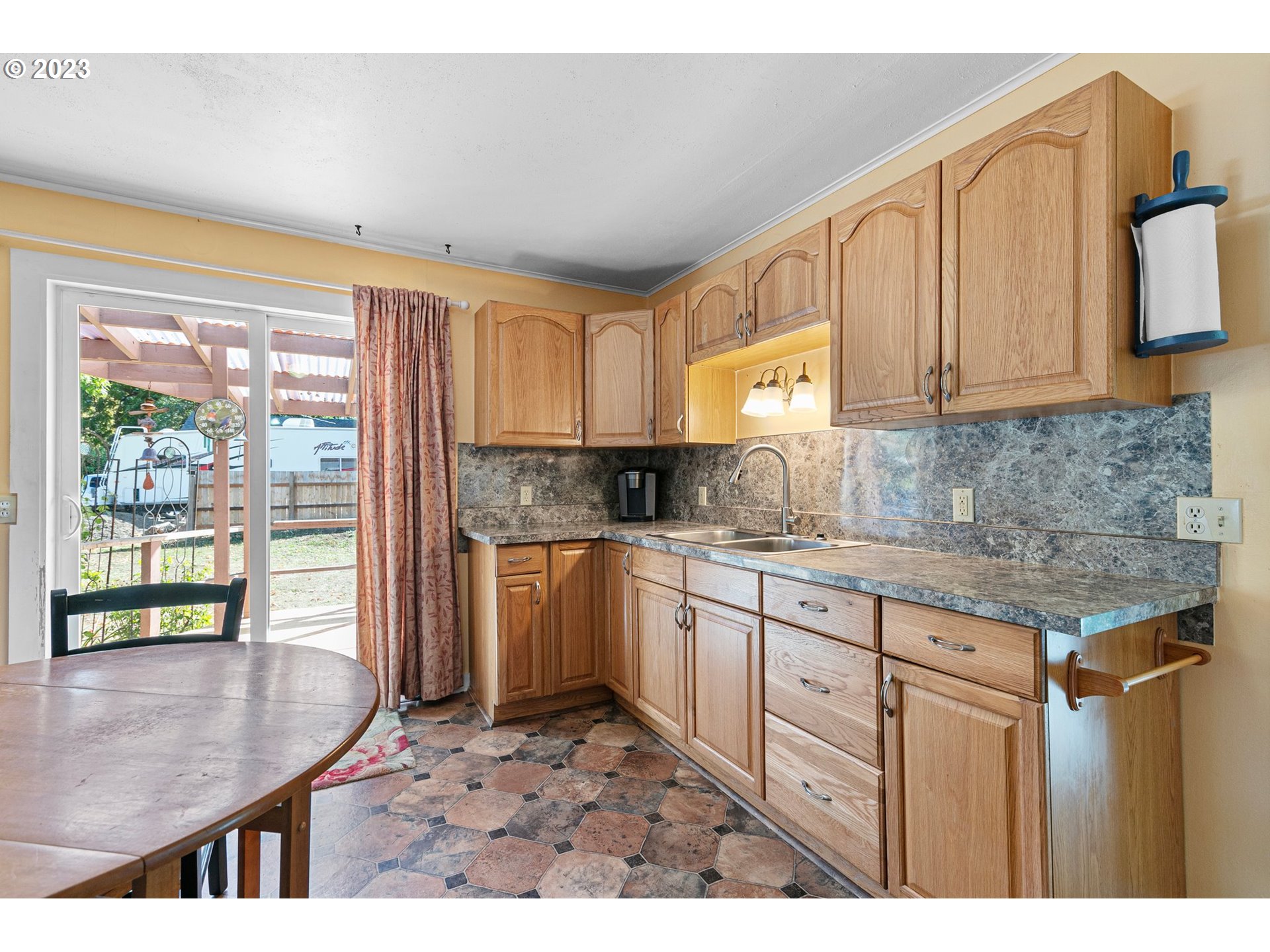 633 South 12th Street Cottage Grove, OR 97424 - Photo 11 of 30 a kitchen with granite countertop a stove a sink and a granite counter tops