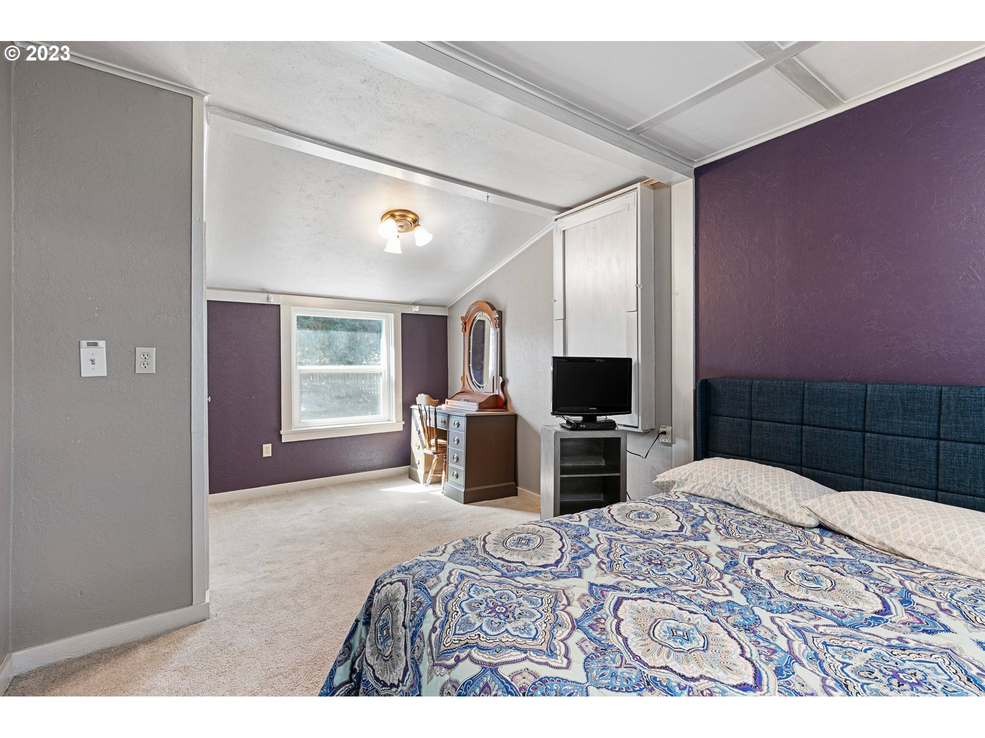 633 South 12th Street Cottage Grove, OR 97424 - Photo 16 of 30 a bedroom with a bed a television and a large window