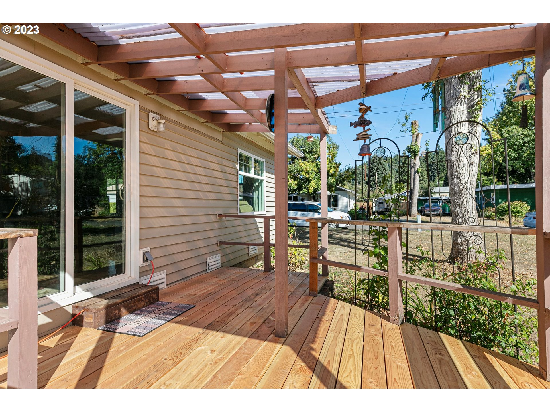 633 South 12th Street Cottage Grove, OR 97424 - Photo 28 of 30 a view of a patio with a table and chairs under an umbrella with a small yard