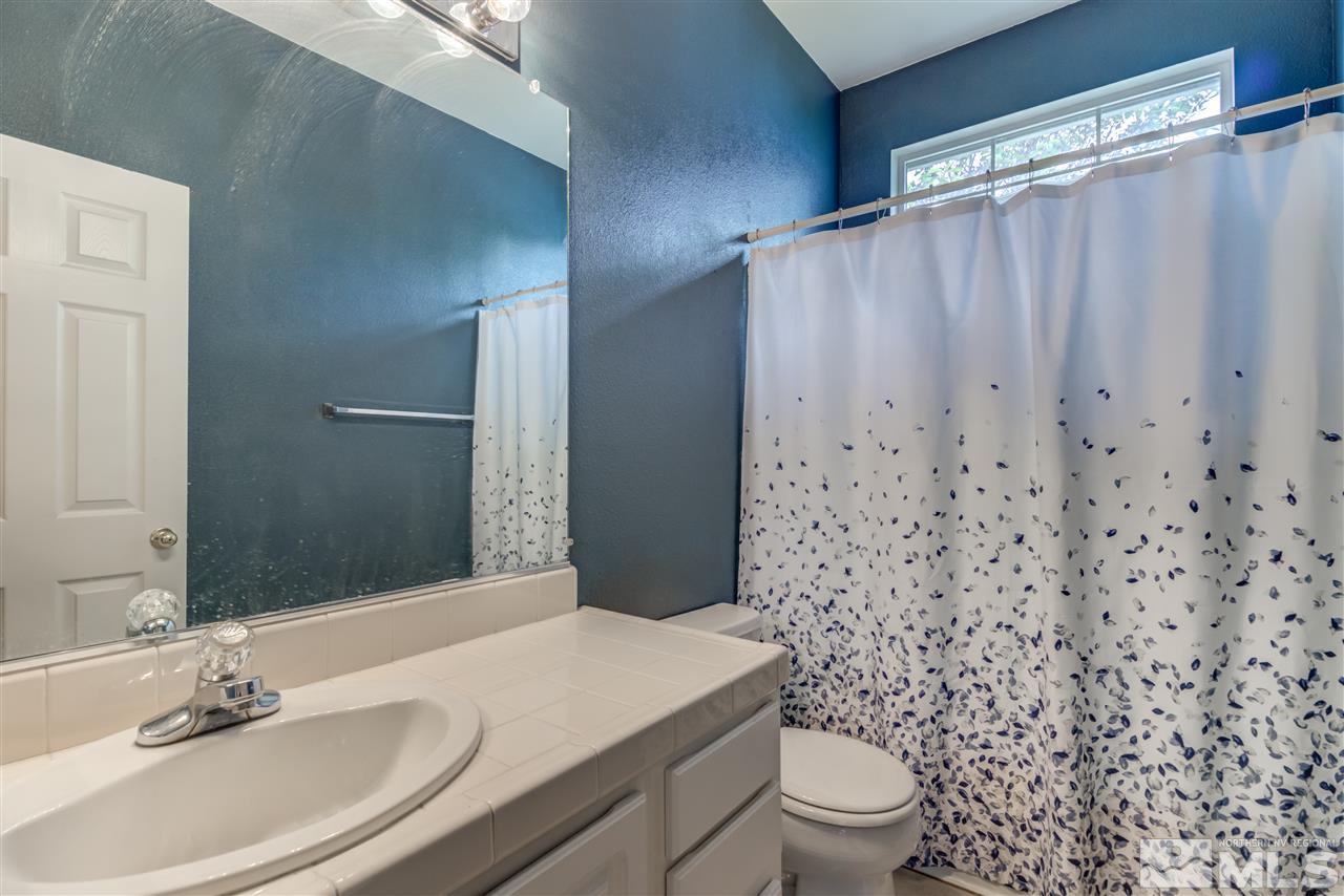 9724 Ripple Way Reno, NV 89521 - Photo 15 of 19 a bathroom with a sink toilet and shower