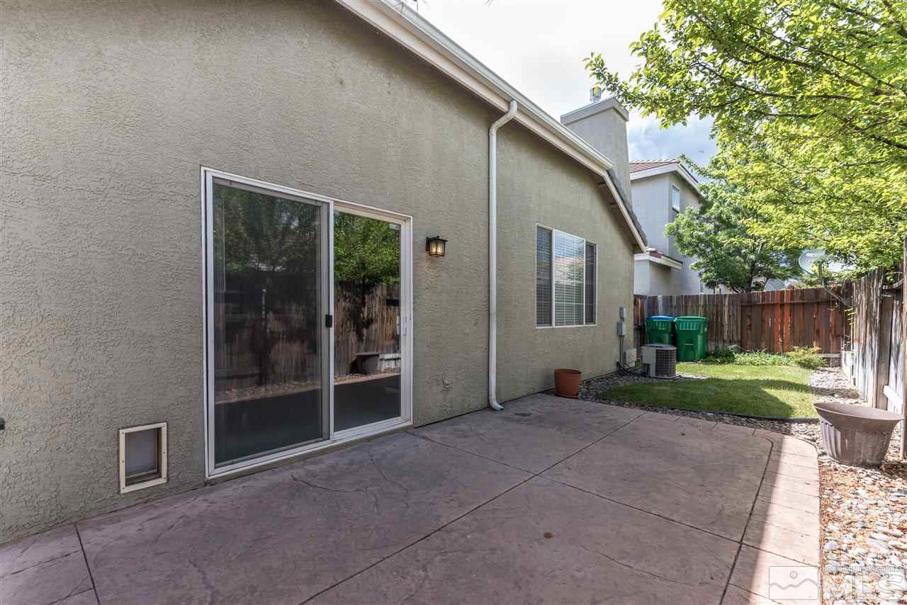 9724 Ripple Way Reno, NV 89521 - Photo 17 of 19 a view of a house with backyard and a garden
