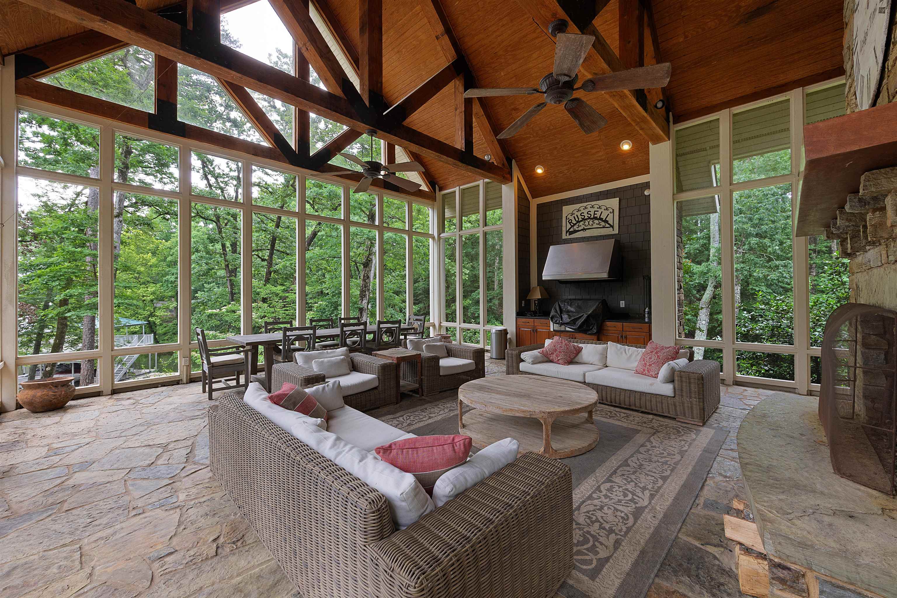 25 Caney Hollow Road Counce, TN 38326 - Photo 12 of 40 Sunroom / solarium with a ceiling fan, high vaulted ceiling, an outdoor living space with a fireplace, and stone finish flooring