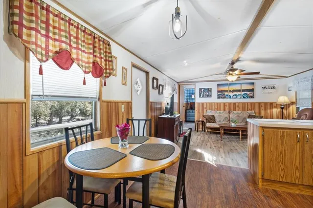 a dining room with furniture a rug and wooden floor